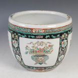 A Chinese porcelain famille verte jardiniere, Qing Dynasty, decorated with four rectangular shaped