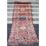 A Persian runner, late 19th / early 20th century, the rectangular field decorated with seven