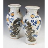 A pair of Chinese porcelain crackle glazed vases, decorated in relief with birds perching on rock-