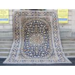 A 20th century Persian Kashan carpet, the indigo field with polychrome palmette arabesques,