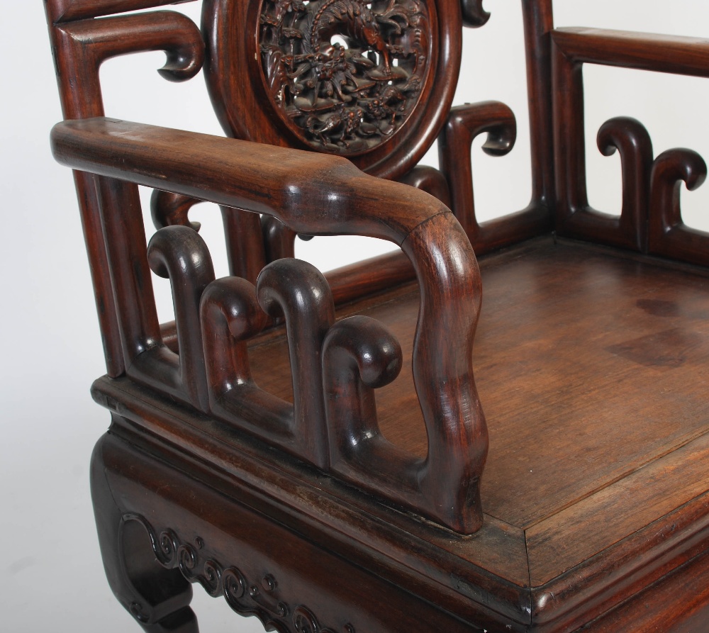 A Chinese carved darkwood armchair, late 19th/ early 20th century, the shaped back rail enclosing - Image 4 of 7