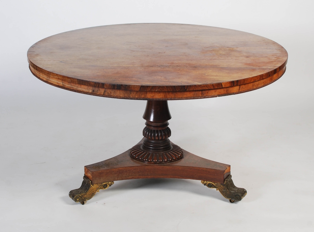 A 19th century rosewood breakfast table, plain round veneered top with beaded rim over a turned