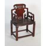 A Chinese carved darkwood armchair, late 19th/ early 20th century, the shaped back rail with a