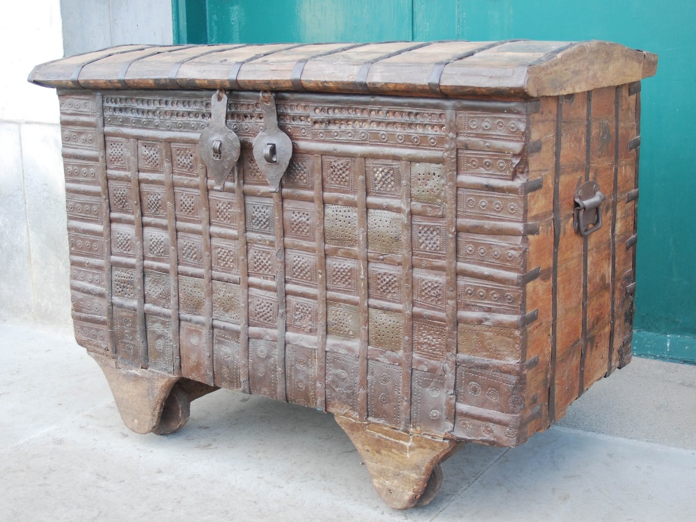 A late 19th/ early 20th century Indian pine and metal bound dowry chest, the domed hinged cover