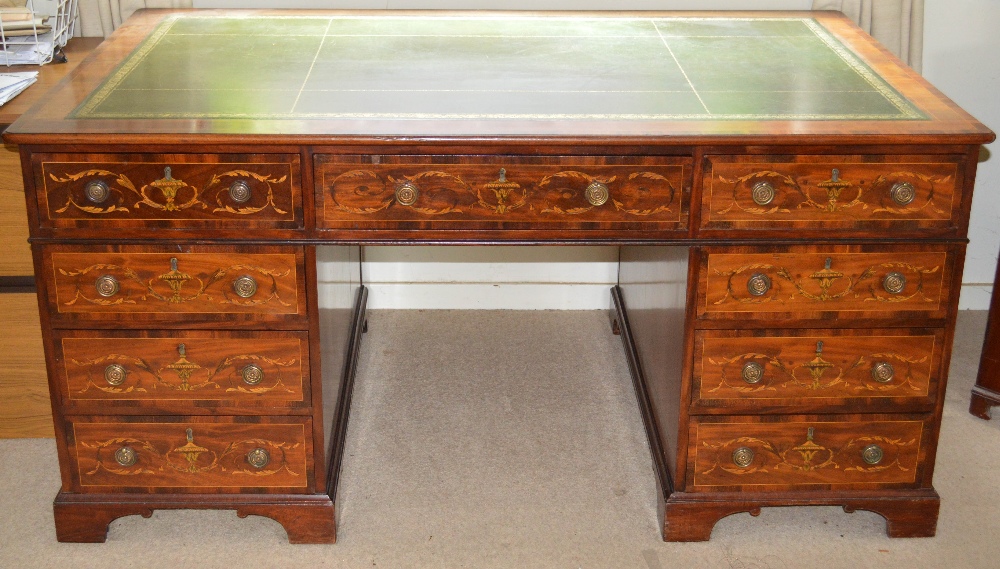 A 19th century mahogany and marquetry inlaid partners desk, the rectangular top with green and