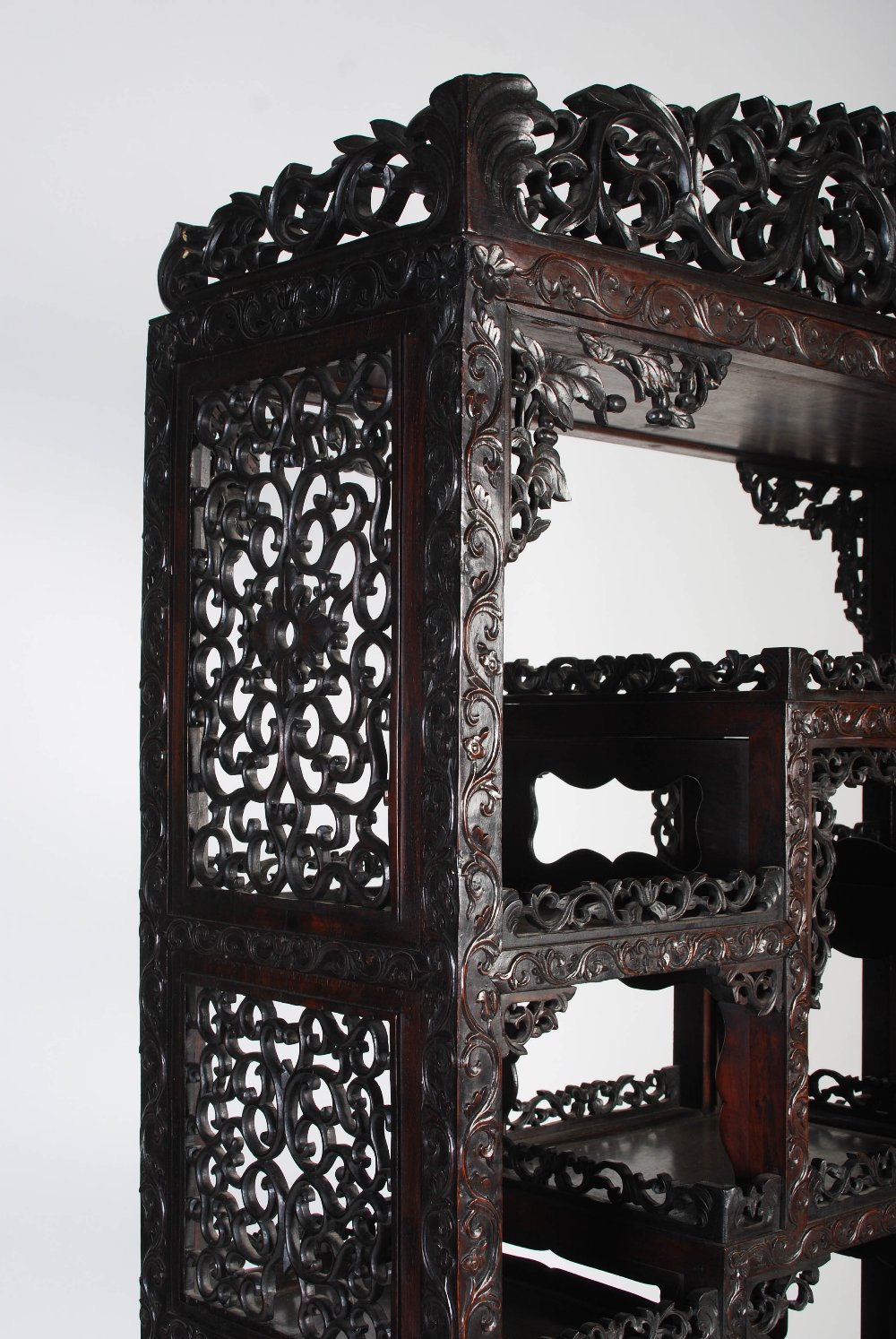 A Chinese carved darkwood display cabinet, Qing Dynasty, the arched top with a carved pediment - Image 2 of 11