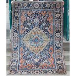 A Persian rug, late 19th / early 20th century, the abrashed rectangular blue ground centred with a