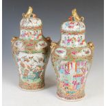 A pair of Chinese porcelain famille rose Canton jars and covers, Qing Dynasty, decorated with