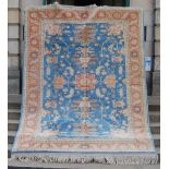 A 20th century Persian carpet, the pale blue field with five cream and orange palmette medallions,