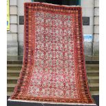 A 20th century Persian rug, the rectangular grey coloured ground decorated with stylised flowers and