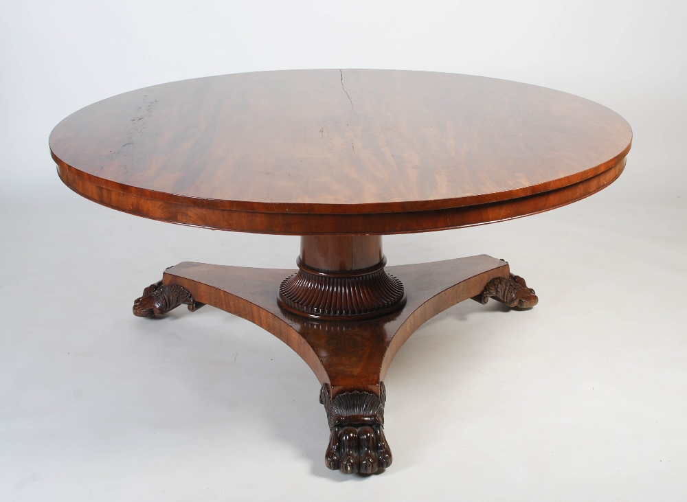 A large 19th century mahogany snap top dining table, the hinged circular top on a plain column