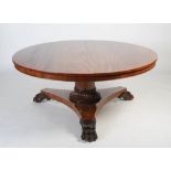 A large 19th century mahogany snap top dining table, the hinged circular top on a plain column