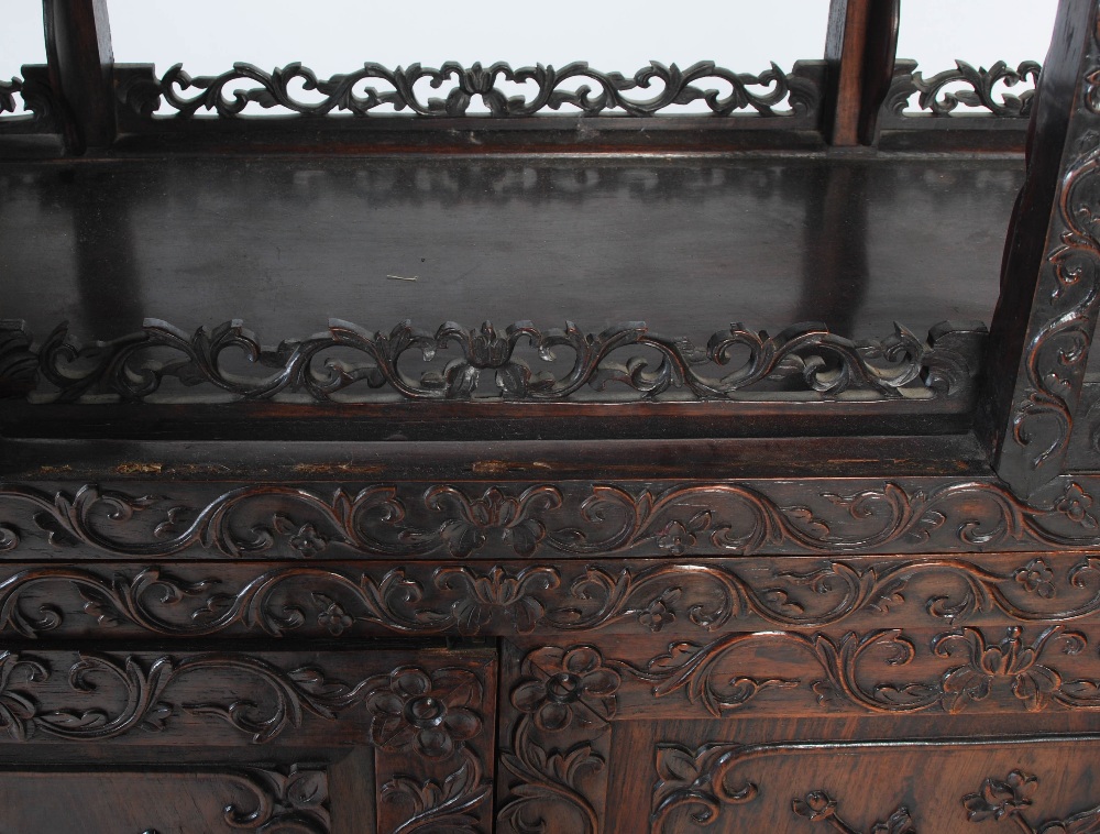 A Chinese carved darkwood display cabinet, Qing Dynasty, the arched top with a carved pediment - Image 10 of 11