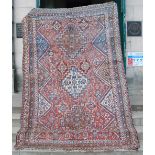 An antique Persian carpet, the pink field with rich pattern of polychrome medallions and rosettes