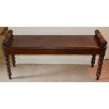 A 19th century stained pine hall bench, the rectangular top with turned cylindrical handles,