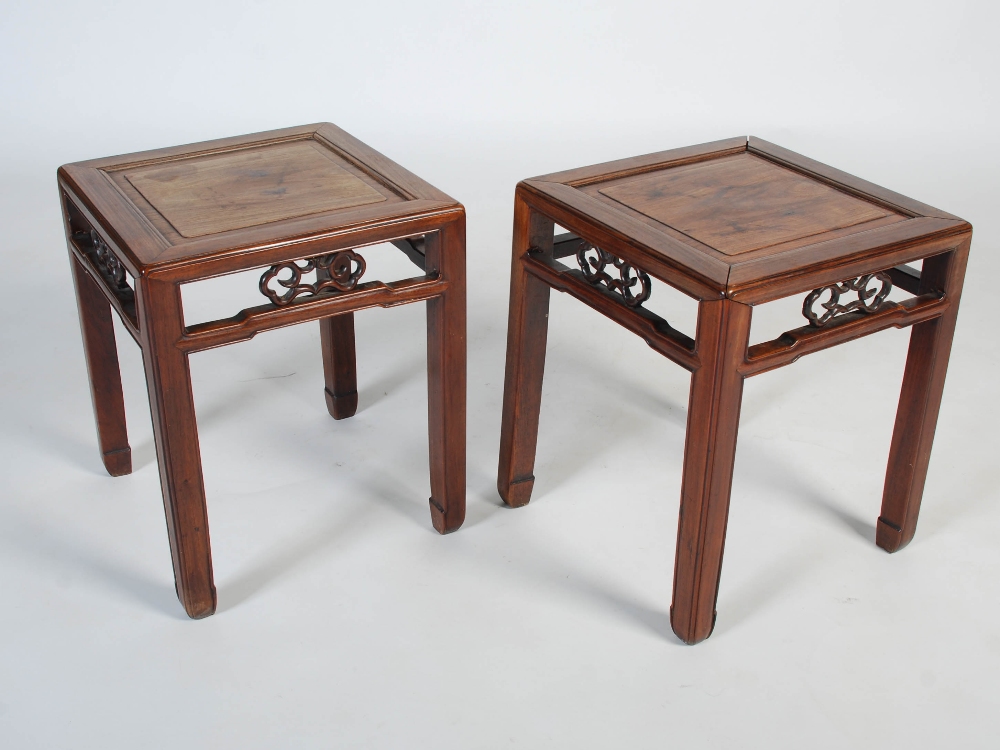 A pair of Chinese darkwood square occasional tables, Qing Dynasty, rectangular tops with recessed