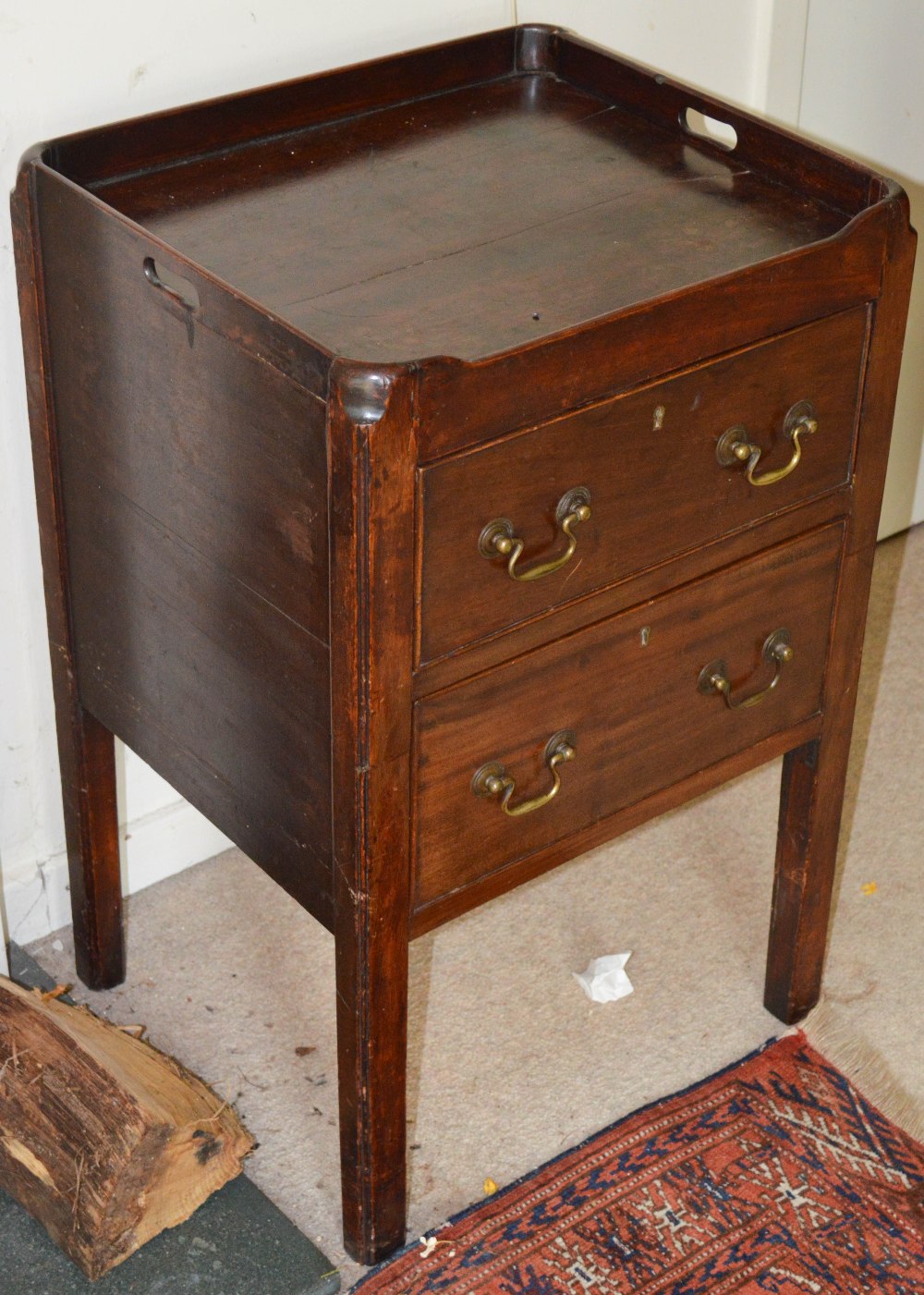 A George III mahogany commode, converted to accommodate two cockbeaded drawers, raised on four