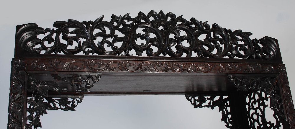 A Chinese carved darkwood display cabinet, Qing Dynasty, the arched top with a carved pediment - Image 6 of 11