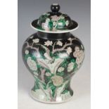 A Chinese porcelain famille verte jar and cover, Qing Dynasty, decorated with bird perching on a