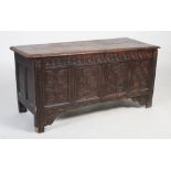A 17th century and later oak mule chest, the carved floral panelled front with rosette borders