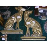 PAIR OF BRASS DOORSTOPS CAST IN THE FORM OF SEATED DOGS