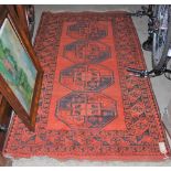 A 20TH CENTURY PERSIAN RUG, THE RECTANGULAR MADDER GROUND DECORATED WITH FOUR OCTAGONAL SHAPED