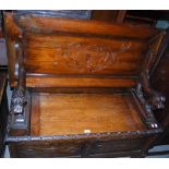LATE 19TH/ EARLY 20TH CENTURY OAK MONKS BENCH WITH CARVED LION ARMS