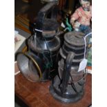 A VINTAGE B.R. WAGON LAMP, AND A BLACK PAINTED PARAFFIN BURNING OIL LAMP