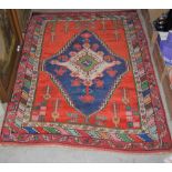 TURKISH RUG, DASKARI, THE RECTANGULAR ORANGE GROUND CENTRED WITH A LARGE BLUE GROUND LOZENGE