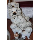 PAIR OF POTTERY KING CHARLES SPANIELS WITH GILDED MARKINGS, TOGETHER WITH A PAIR OF SEATED