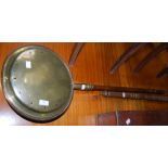 A COPPER AND BRASS BED WARMING PAN WITH TURNED WOODEN HANDLE