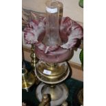 BRASS PARAFFIN BURNING LAMP WITH CRANBERRY TINTED SHADE AND CLEAR GLASS FONT
