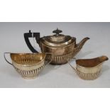 SILVER THREE-PIECE BACHELORS TEA SET, OVAL-SHAPED WITH PART-GADROONED DECORATION, THE TEA POT