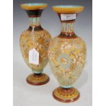 PAIR OF DOULTON STONEWARE VASES WITH INCISED FLORAL DECORATION PICKED OUT IN TURQUOISE AND OCHRE