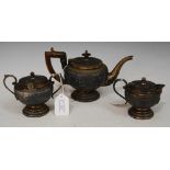 LATE 19TH/ EARLY 20TH CENTURY INDIAN WHITE METAL THREE-PIECE TEA SET, WITH EMBOSSED DECORATION OF