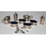 GROUP OF EIGHT SILVER CRUETS, COMPRISING FOUR OVAL SALT CELLARS WITH BLUE GLASS LINERS, TWO MUSTARD
