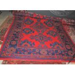 LATE 19TH/ EARLY 20TH CENTURY RED GROUND USHAK CARPET WORKED IN BLUE AND GREEN THREADS WITH
