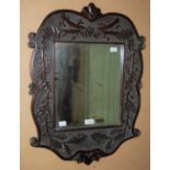 A MAHOGANY FRAMED WALL MIRROR WITH ACORN DETAIL AND FOLIATE CARVED BORDER TOGETHER WITH A GILT