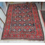 BALUCHI RUG, THE RECTANGULAR GROUND DECORATED WITH ROWS OF STYLISED FLOWERS AND FOLIAGE ON A BLUE