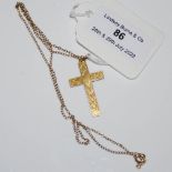 A 9CT GOLD CRUCIFIX SHAPED PENDANT SUSPENDED ON YELLOW METAL CHAIN, STAMPED 9C, GROSS WEIGHT 2