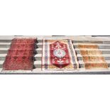 GROUP OF THREE RUGS TO INCLUDE A MADDER GROUND LONG RUG DECORATED WITH TWO ROWS OF EIGHT LOZENGE-