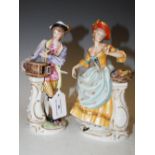 A PAIR OF CONTINENTAL PORCELAIN FIGURE GROUPS, MALE WITH BIRD CAGE AND BIRD, FEMALE WITH BASKET OF