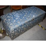 A VINTAGE UPHOLSTERED RECTANGULAR OTTOMAN WITH OVAL SILVERED HANDLE