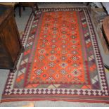 SHIRAZ KILIM FLATWEAVE RUG, THE RECTANGULAR ORANGE GROUND DECORATED WITH ALLOVER DESIGN OF