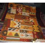 KILIM FLATWEAVE RUG, 20TH CENTURY WORKED IN YELLOW, ORANGE, BROWN AND GREEN COLOURED THREADS,