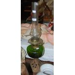 A LATE 19TH CENTURY CAST METAL PARAFFIN BURNING OIL LAMP WITH GREEN GLASS RESERVOIR, OPAQUE WHITE