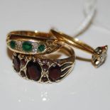 A COLLECTION OF THREE RINGS TO INCLUDE A 9CT GOLD AND GARNET DRESS RING, 18CT GOLD EMERALD AND