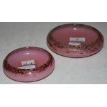 TWO MONART PIN DISHES OF ASSORTED SIZE, BOTH MOTTLED PURPLE AND PINK WITH GOLD COLOURED