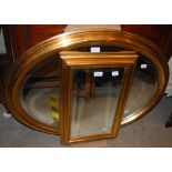 GILT FRAMED BEVELLED GLASS OVAL WALL MIRROR, APPROX. 63CM HIGH X 84CM WIDE, TOGETHER WITH A GILT