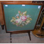 AN ANTIQUE OAK AND GREEN FLORAL TAPESTRY FIRE SCREEN